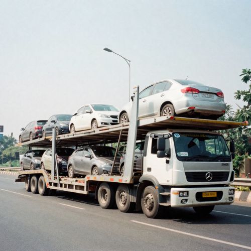 Car transportation services in Delhi showing a multi-level vehicle carrier truck loaded with several cars being safely transported on a highway, representing professional and secure vehicle shifting services.